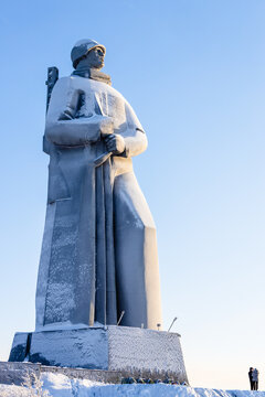 Murmansk, Russia - February 11, 2026: tourists and Monument To Defenders of the Soviet Arctic during the Great Patriotic War World War II (Alyosha) at Zelenaya hill on Cape Green on sunny winter day