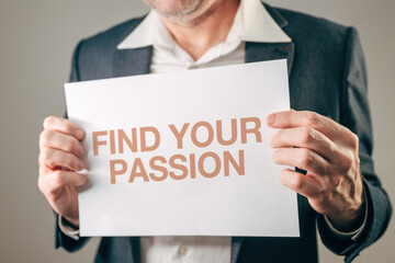 Fototapeta premium Businessman motivational speaker holding sign with FIND YOUR PASSION motivational text