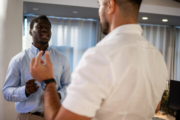 Fototapeta premium Two businessmen engaged in serious office discussion