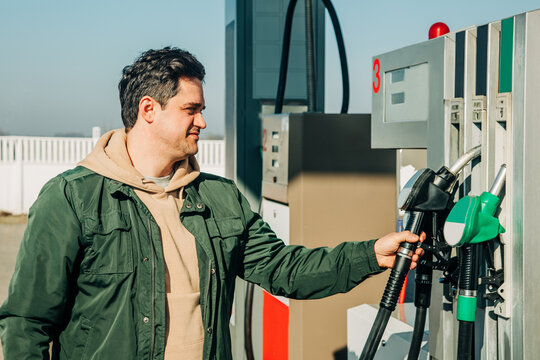 A man fills his car with gas during the fuel crisis