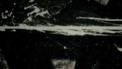 Obraz premium Abstract grunge texture with white scratches on dark background