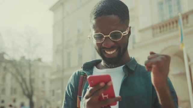 Excited individual displaying happiness on sunny street, Person exudes joy after winning amid lively traffic scene