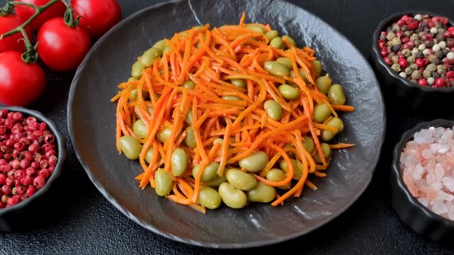 Asian salad with edamame beans, carrots, tofu, and spices. Edamame and carrot salad as a food background for your design