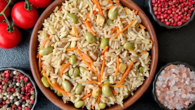 Asian food with rice, edamame, carrots, tofu, and spices. Rice with edamame and carrots as a food background for your design