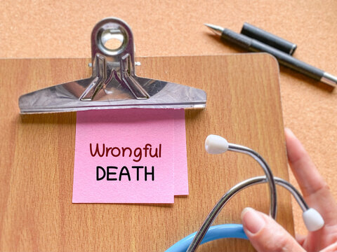 Clipboard with wrongful death note and stethoscope representing medical malpractice lawsuit and healthcare legal claim concept.