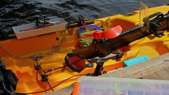Fully rigged kayak watercraft for kayaking lake during tournament or fishing derby. Kayak water craft equipment for fishing game activities. Fishing kayak in calm lake waters. Recreational watercraft.