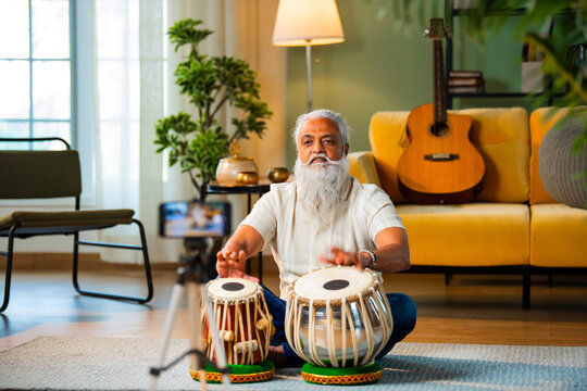 Modern Indian tabla artist focused on daily practice session in modern home