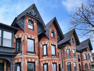 Naklejka premium Row of narrow Victorian brick houses with gables