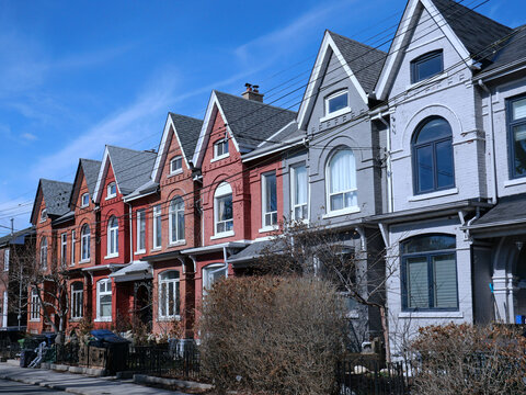 Row of narrow Victorian brick houses with gables