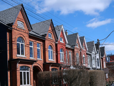Row of narrow Victorian brick houses with gables