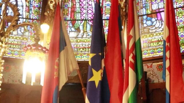 International country flags mounted on the wall inside a historic synagogue