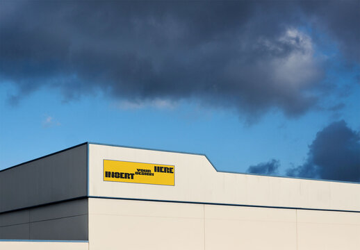 Real photo of Storefront Seen Under Cloudy Sky. PSD template mockup.