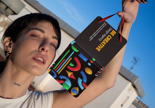Real photo of woman Holding Notebook Under Blue Sky. PSD template mockup.