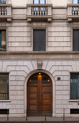 Obraz premium Symmetrical wooden entrance door in historic European building facade