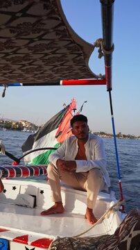 Relaxed Traveler Enjoying Felucca Ride on the Nile River in Luxor Egypt