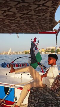 Traveler Sailing Traditional Felucca on the Nile in Luxor Egypt