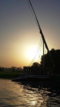 Golden Sunset Over the Nile River with Felucca Sailboat in Luxor