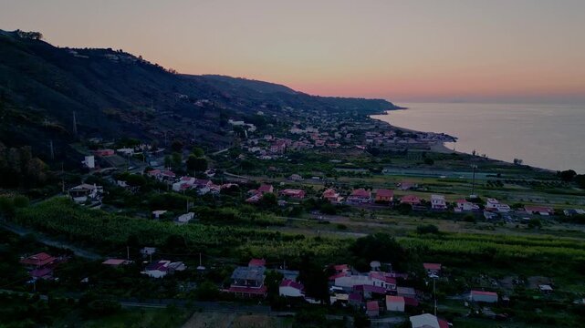 Cinematic aerial drone panorama of Ganzirri and Capo Peloro, Sicily. Stunning coastal landscape near Messina with the Lakes of Ganzirri and the narrow sea channel between Tyrrhenian and Ionian waters