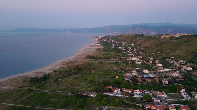 Cinematic aerial drone panorama of Ganzirri and Capo Peloro, Sicily. Stunning coastal landscape near Messina with the Lakes of Ganzirri and the narrow sea channel between Tyrrhenian and Ionian waters