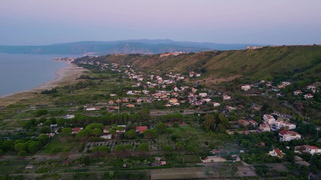 Cinematic aerial drone panorama of Ganzirri and Capo Peloro, Sicily. Stunning coastal landscape near Messina with the Lakes of Ganzirri and the narrow sea channel between Tyrrhenian and Ionian waters