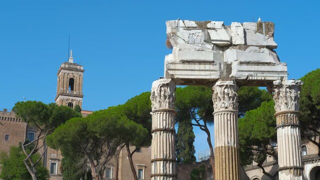 Roman forum temple ruins tilting upwards. Tilting up shot of the ancient ruins of the temple of castor and pollux in the roman forum, revealing the iconic corinthian columns and capitals
