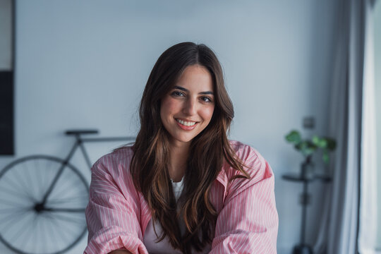 Happy pretty millennial girl home head shot portrait. Young confident business woman in casual, entrepreneur, blogger posing at home office workplace table enjoying indoor, smiling at camera