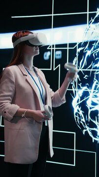 Vertical video Admin wearing VR headset gear reports to AI brain displayed on digital dashboard. Worker completes assignments distributed by artificial intelligence superintelligence using virtual