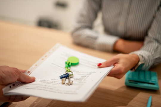 Client completing property agreement, receiving new keys