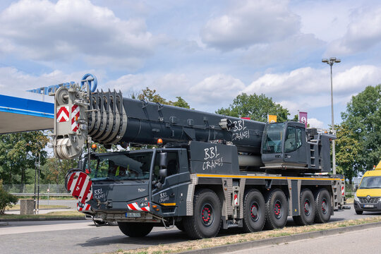 Darmstadt, Germany - July 15th 2020 : View on a grey mobile crane Tadano ATF 220G-5 parked on a street.