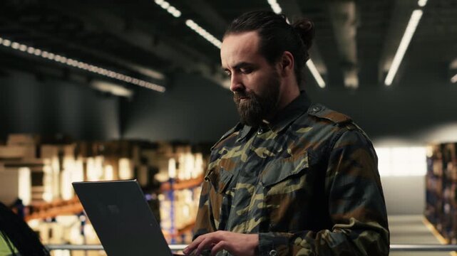 Army soldier, defense mission, logistics and distribution, military base, monitoring cargo shipment and parcel tracking on laptop. Male officer in uniform manages supply chain process.