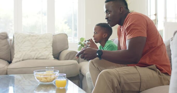 African American father and child starting game to play after father showing controller on sofa