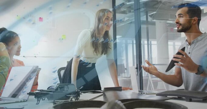 Standing woman leaning on table starting design review around drone, graphics overlaying tablet