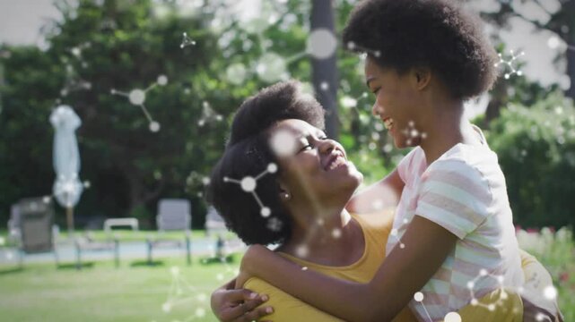 Mother lifting daughter after hug, supporting, molecular overlay highlighting health, showing love