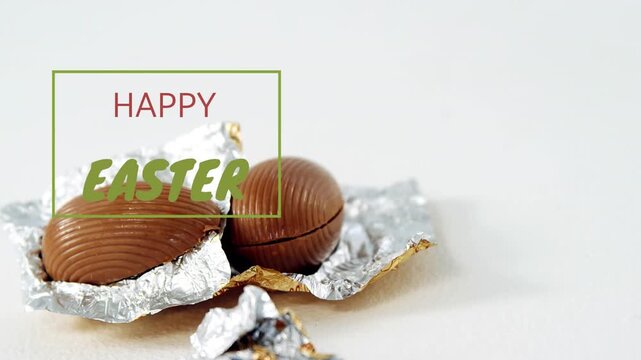 Green greeting sliding in, causing camera zooming, revealing chocolate eggs on torn foil for Easter