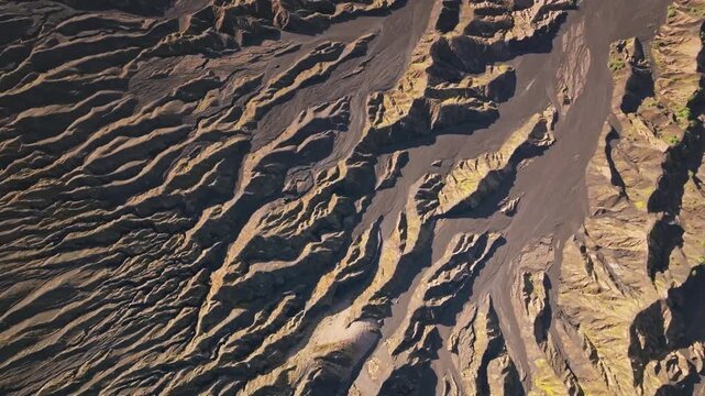 Ambrym Island volcanic landscape captured from an aerial perspective, textured patterns of dried lava flows and erosion channels near the craters of Benbow and Marum volcanoes. Natural background