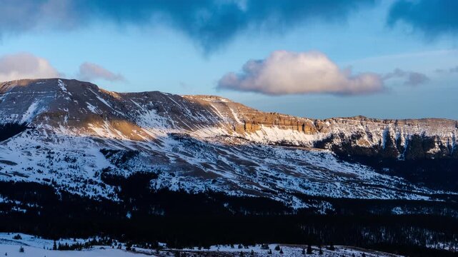 Sunset on mountain range in winter timelapse 