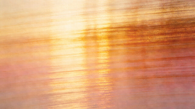 Ethereal soft-focus abstract texture with blurred light streaks and vertical flowing patterns transitioning to warm sunset tones of gold, amber, and soft peach. Dreamy high-key lighting creates a...