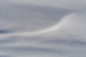 Fototapeta premium Gentle silver-grey waves flow across a fine grain surface, creating a calm abstract background ideal for modern branding, packaging, or minimalist digital designs.
