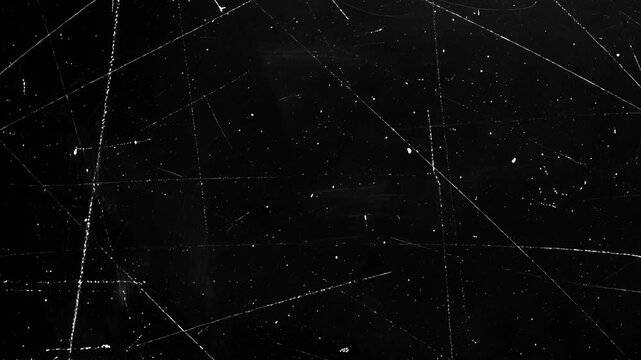 Vintage Scratched Film Texture Loop.Grungy black background with white dust and scratches for cinematic retro overlays and analog video effects.