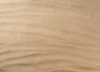 Sand background texture as background, top view. close up the texture of the sand on the beach, topview. © Igor Dudchak
