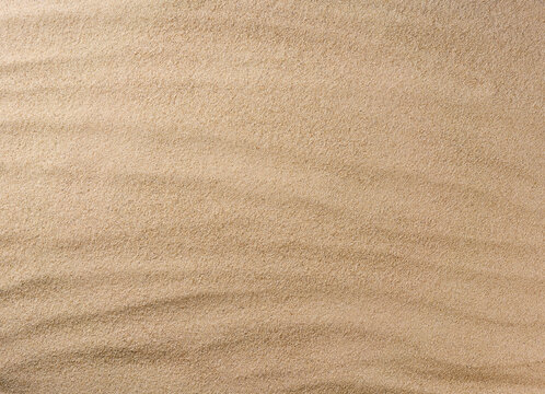 Sand background texture as background, top view.
close up the texture of the sand on the beach, topview.
