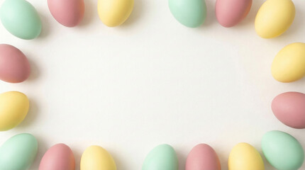 Fototapeta premium Rectangular frame composed of soft pastel-colored Easter eggs arranged on a blank white background, providing central copy space.
