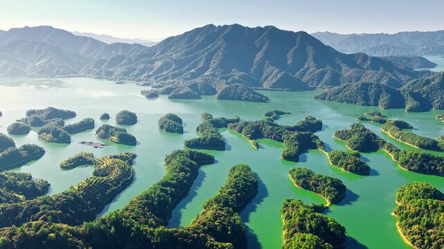 High angle view of lush green islands scattered across Thousand Island Lake under clear sky in Hangzhou, China.