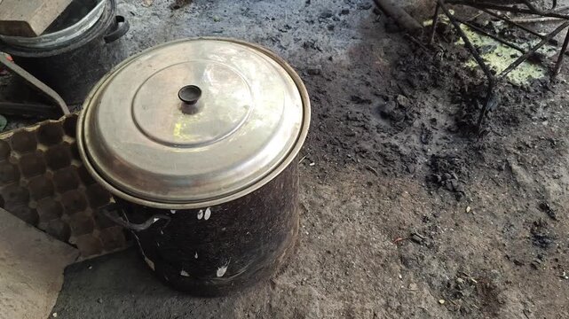Hand closing a metal container full of dried corn kernels