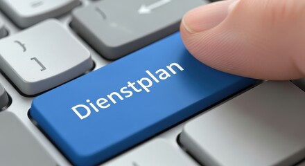 Finger Pressing Blue Dienstplan Button on Keyboard for German Shift Schedule and Roster Concept
