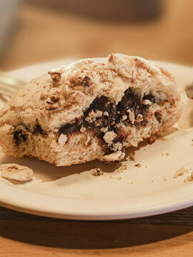 Mexican sweet bread Concha sliced in half and filled with hazelnut chocolate cream on dark background