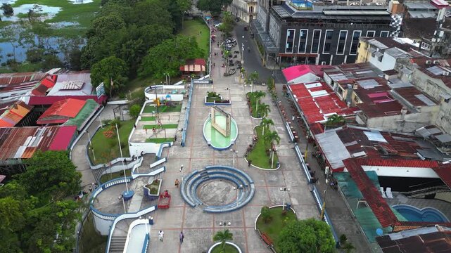 High-resolution aerial view of the riverfront boulevard in Iquitos featuring colorful historic buildings, vibrant urban streets, and a scenic promenade along the majestic Amazon River