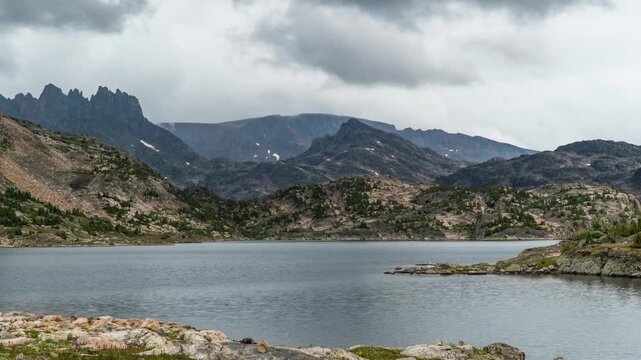 Dark clouds moving over Lower Aero Lake and jagged peaks in the Beartooth Mountains, Montana, time lapse