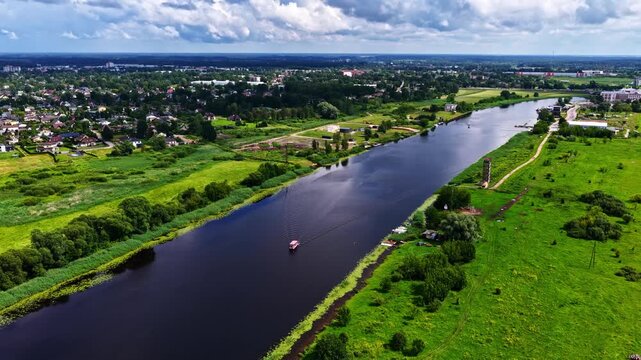 Drone shot of Lielupe River and surrounding landscape in overcast weather