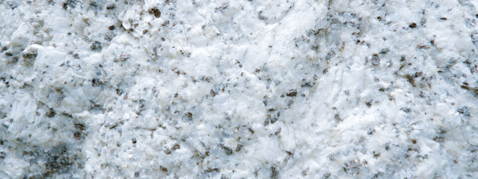 Close up of granite surface texture. Intrusive igneous rock